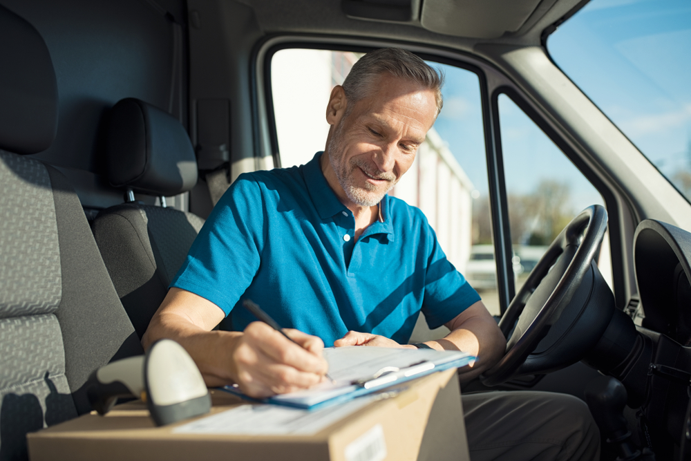 Courier delivery person filling in paperwork